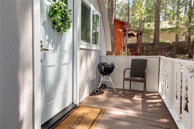 wooden terrace featuring a grill