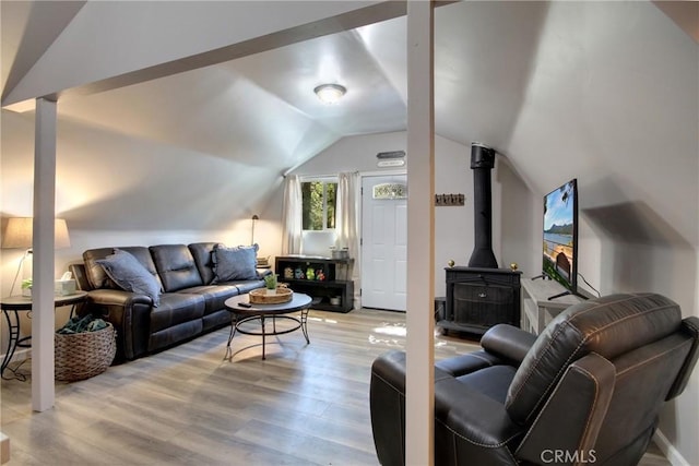living room featuring light hardwood / wood-style floors and vaulted ceiling
