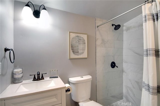 bathroom featuring vanity, curtained shower, and toilet
