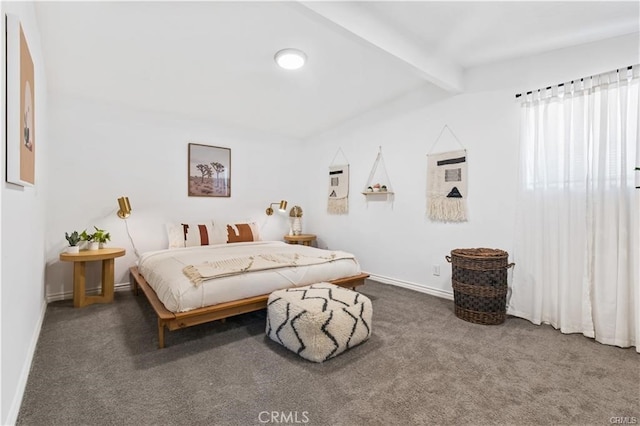 bedroom featuring beam ceiling and dark carpet