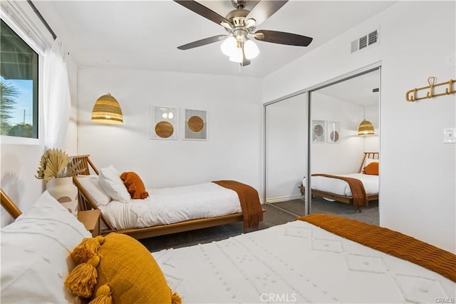 bedroom featuring a closet, dark carpet, and ceiling fan