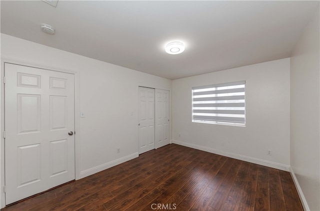 unfurnished room with dark hardwood / wood-style floors