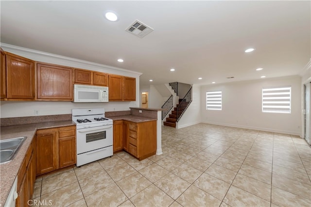 kitchen featuring white appliances, light tile patterned flooring, sink, kitchen peninsula, and crown molding