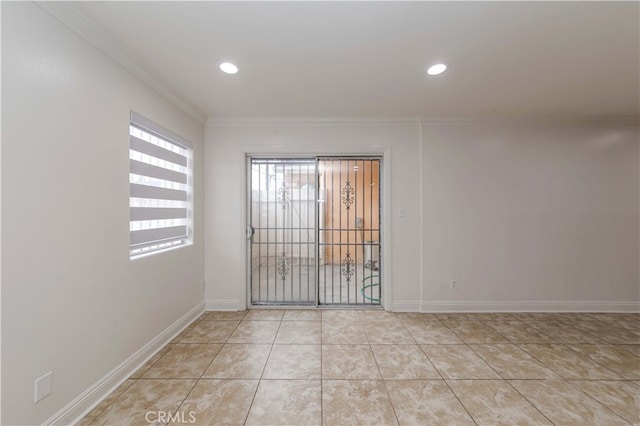 tiled spare room featuring ornamental molding