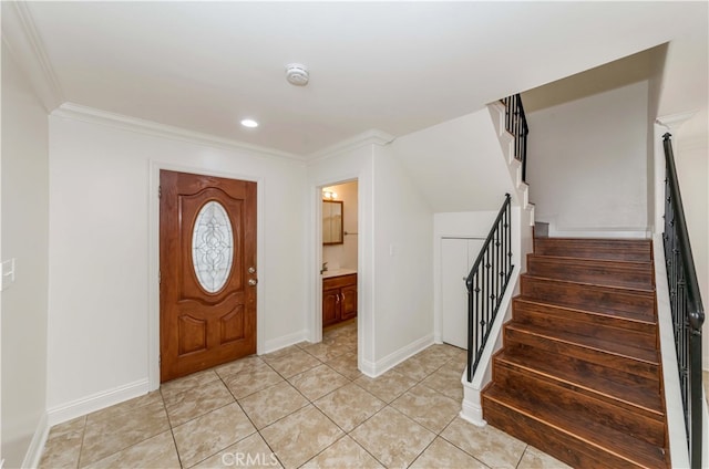 tiled foyer entrance with ornamental molding