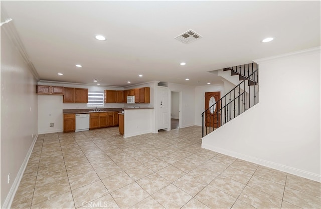 kitchen featuring crown molding, dishwasher, sink, and light tile patterned floors