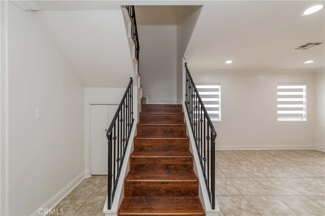 stairway featuring tile patterned flooring