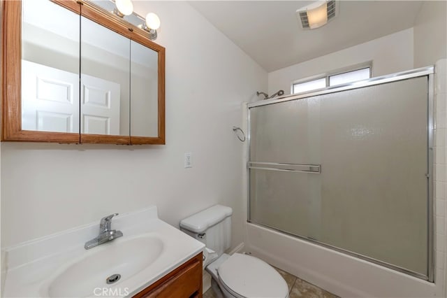 full bathroom with vanity, toilet, tile patterned flooring, and bath / shower combo with glass door