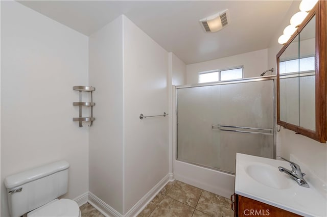 full bathroom with toilet, vanity, shower / bath combination with glass door, and tile patterned flooring