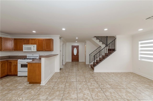 kitchen featuring ornamental molding, light tile patterned floors, and white appliances