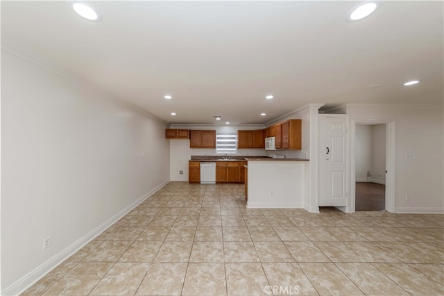 kitchen with crown molding, light tile patterned floors, and white appliances