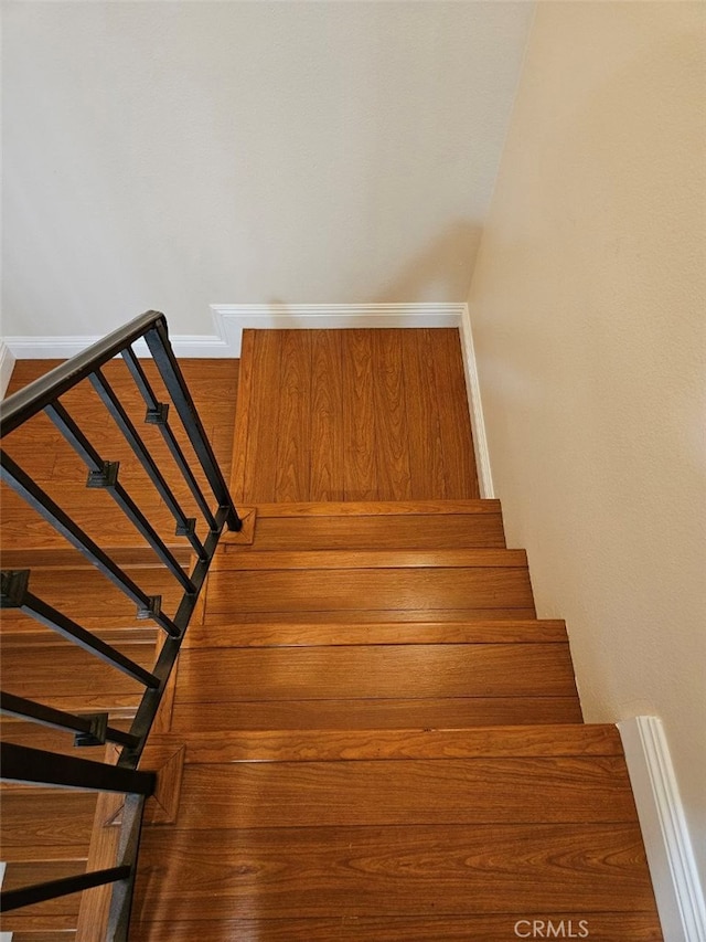 staircase featuring hardwood / wood-style floors