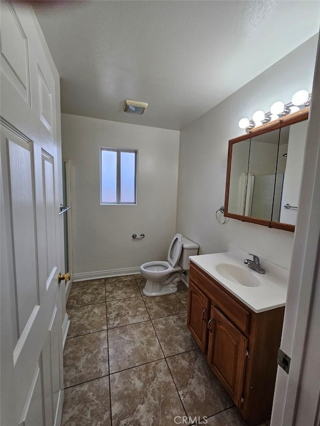 bathroom featuring vanity, toilet, and tile patterned flooring