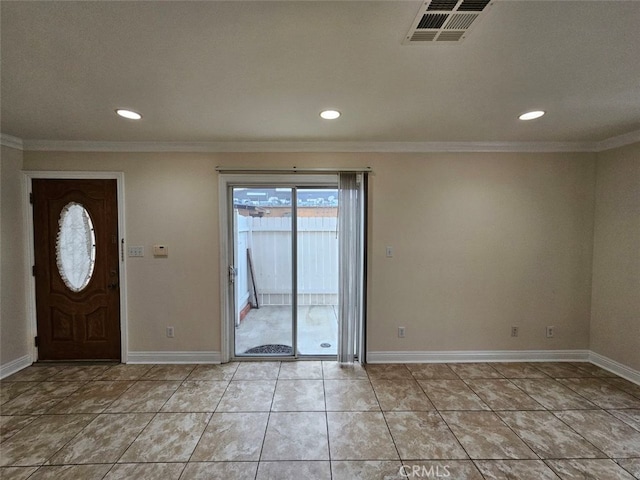 foyer featuring crown molding and light tile patterned floors