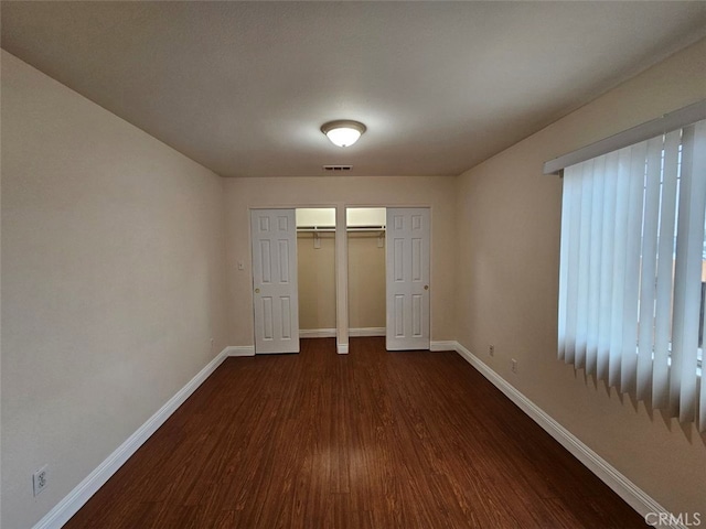 unfurnished bedroom with dark hardwood / wood-style floors