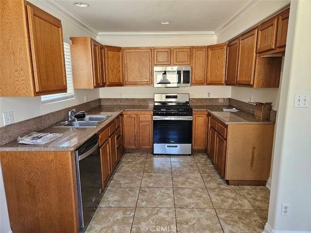 kitchen featuring crown molding, stainless steel appliances, sink, and light tile patterned floors