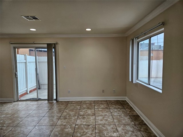 tiled spare room featuring ornamental molding