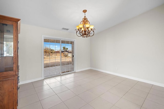 unfurnished dining area featuring an inviting chandelier and light tile patterned flooring