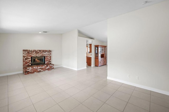 unfurnished living room featuring lofted ceiling, a fireplace, and light tile patterned floors