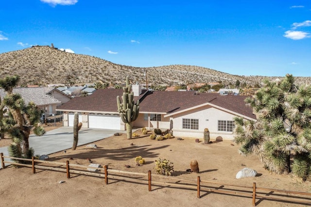 ranch-style house featuring a mountain view and a garage