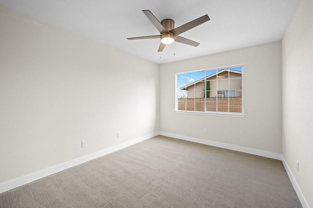 empty room featuring carpet flooring and ceiling fan