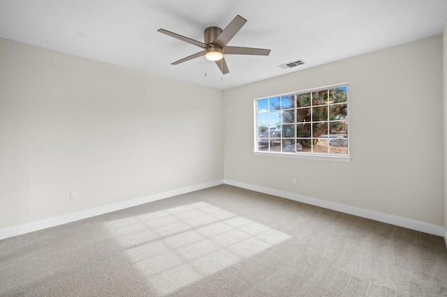 unfurnished room with light carpet and ceiling fan