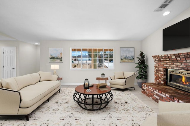 tiled living room with a brick fireplace