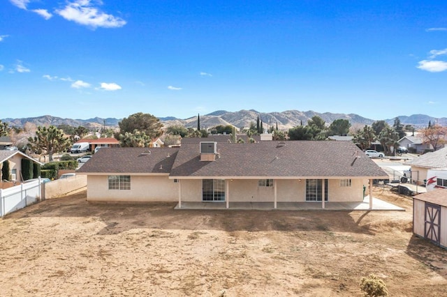 back of property featuring a mountain view and a patio