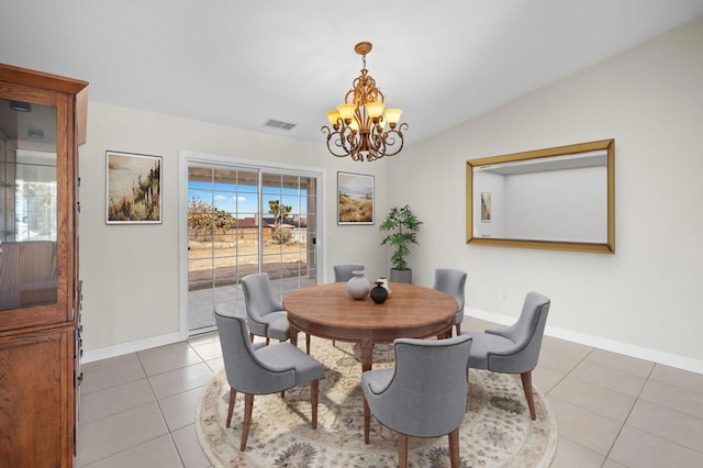 dining room with lofted ceiling, light tile patterned floors, and a chandelier