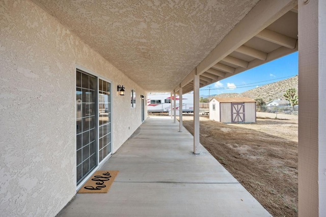 view of patio / terrace featuring a storage shed