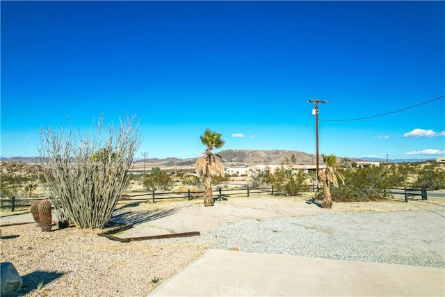 view of yard featuring a rural view and a mountain view