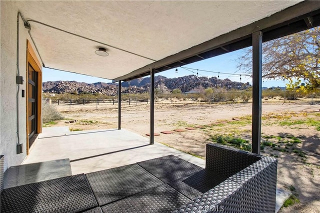 view of patio / terrace featuring a rural view and a mountain view