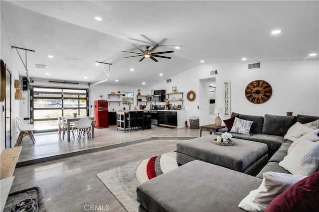 living room featuring ceiling fan and vaulted ceiling