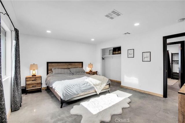 bedroom with concrete floors and a closet