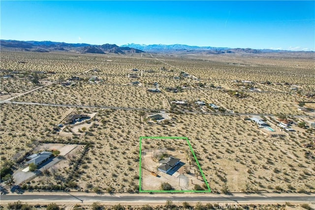 birds eye view of property with a mountain view