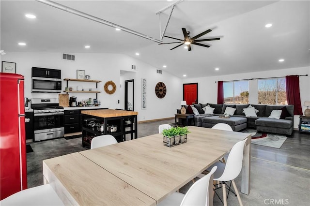 dining area with ceiling fan and vaulted ceiling