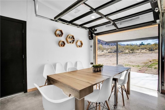 dining room with concrete flooring