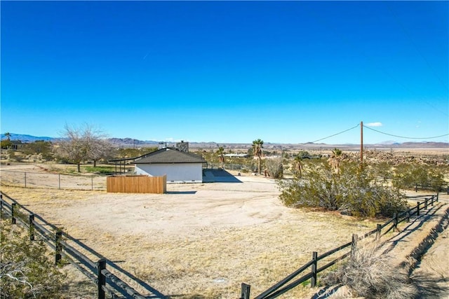 view of yard featuring a rural view and a mountain view