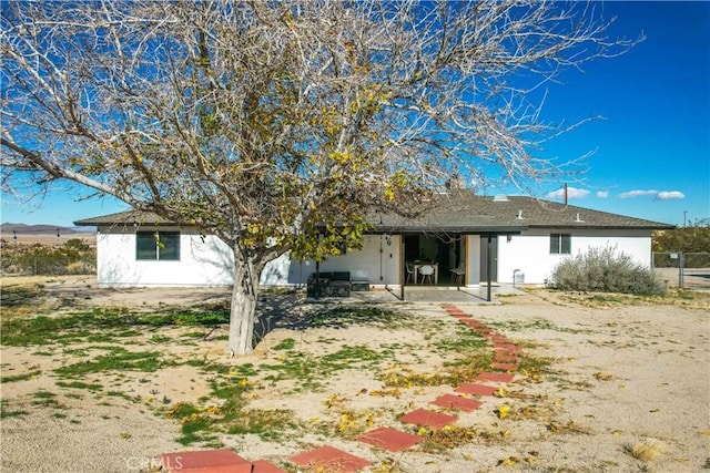 rear view of property featuring a patio