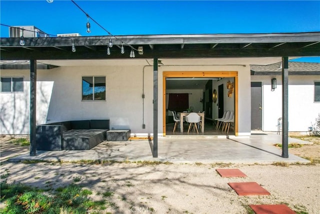 rear view of house featuring a patio and outdoor lounge area