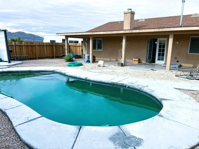 view of pool with a mountain view and a patio