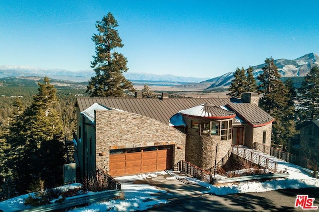 view of front of home with a mountain view and a garage