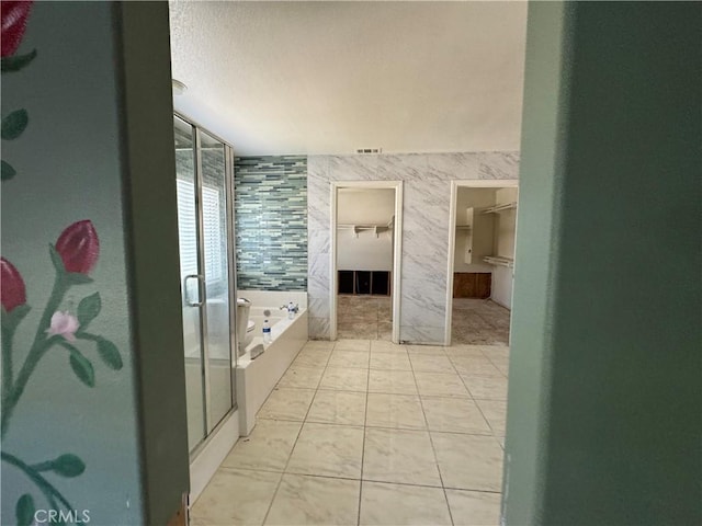 4810 Swallowtail Rd, Hemet, CA 92545 - bathroom featuring a shower stall, a garden tub, a spacious closet, and visible vents