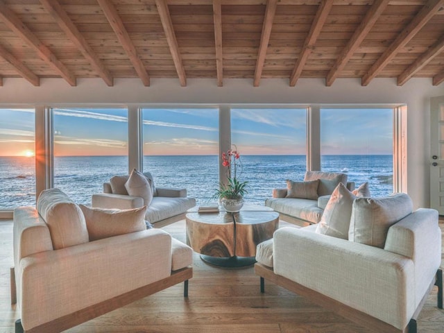 sunroom featuring wooden ceiling, beam ceiling, and a water view