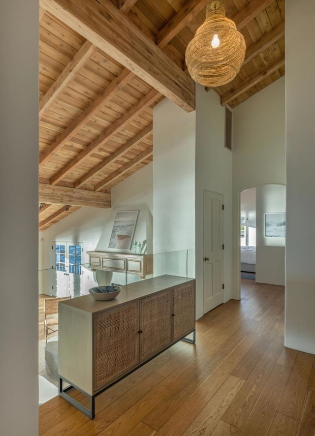 kitchen featuring light hardwood / wood-style floors, plenty of natural light, and beamed ceiling