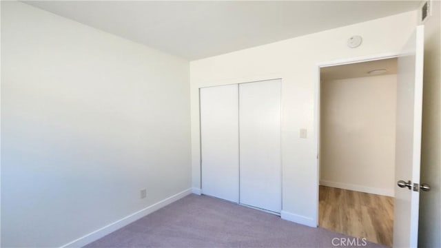 unfurnished bedroom with a closet and carpet