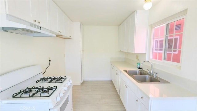 kitchen featuring sink, light hardwood / wood-style flooring, white range with gas cooktop, white cabinets, and exhaust hood