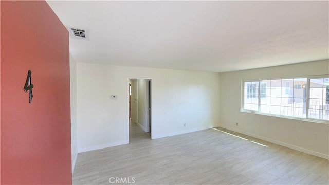 spare room featuring light hardwood / wood-style floors