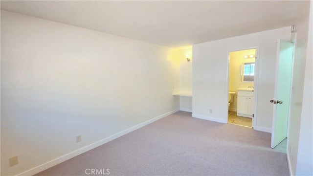 unfurnished room featuring light colored carpet