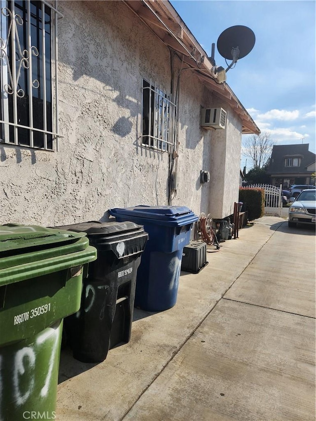 view of property exterior featuring a wall mounted air conditioner